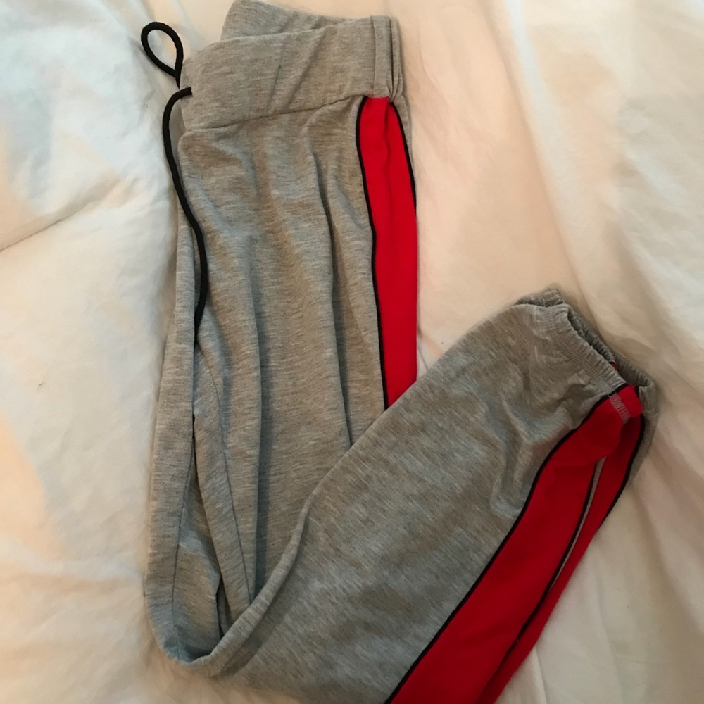 grey joggers with red strip